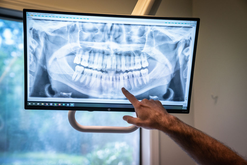 dentist looking over dental x-ray